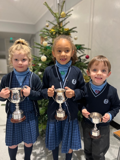 students with trophies