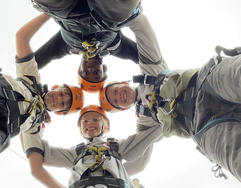 children wearing orange helmets
