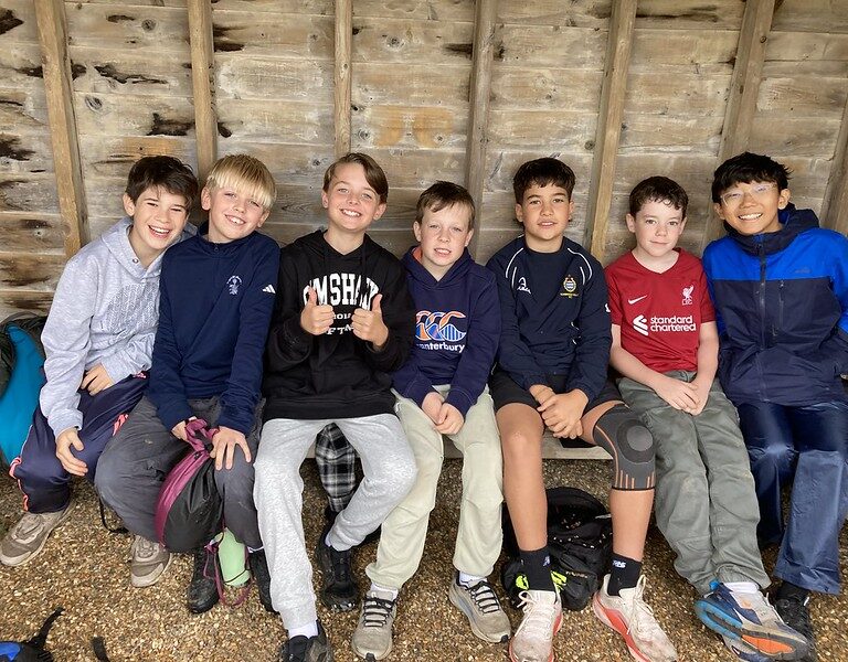 row of boys sitting on a bench