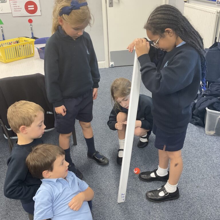 school kids in class with a giant ruler